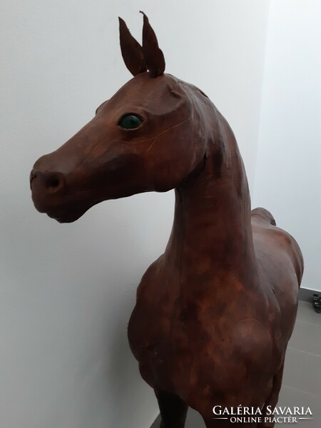 Large, antique leather horse statue