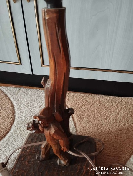 Hand-carved wooden table lamp with woodcutter