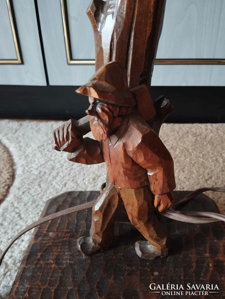 Hand-carved wooden table lamp with woodcutter