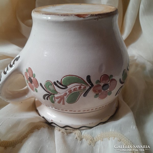 Ceramic glazed jug with a flower motif