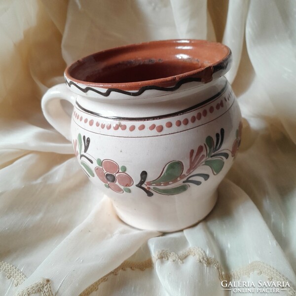 Ceramic glazed jug with a flower motif