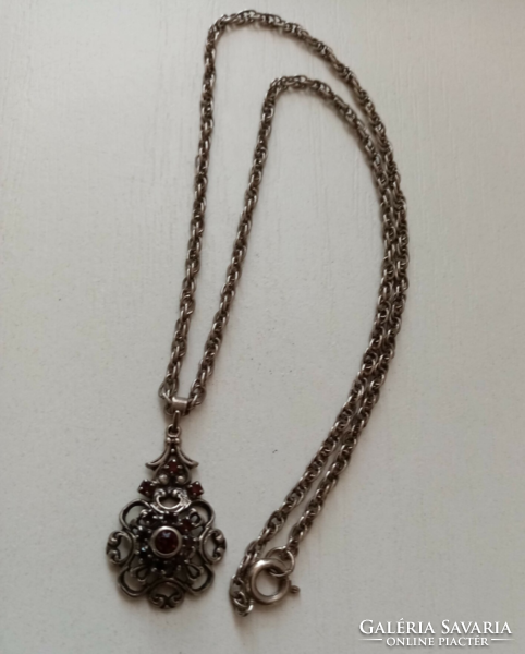 Old silver-plated twisted necklace with a pendant studded with openwork pattern red stones