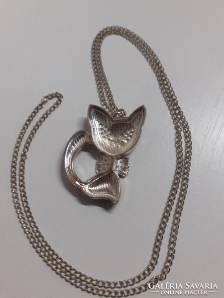 A long silver-colored chain in nice condition with a black cat and many sparkling white stones on it