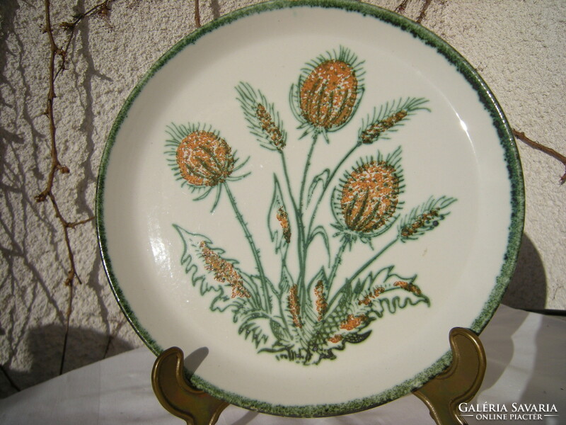 A majolica plate with an ear of wheat and a bouquet of poppies