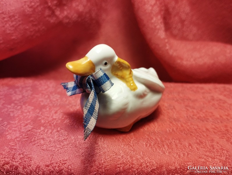 Miniature porcelain duck in an interesting pose