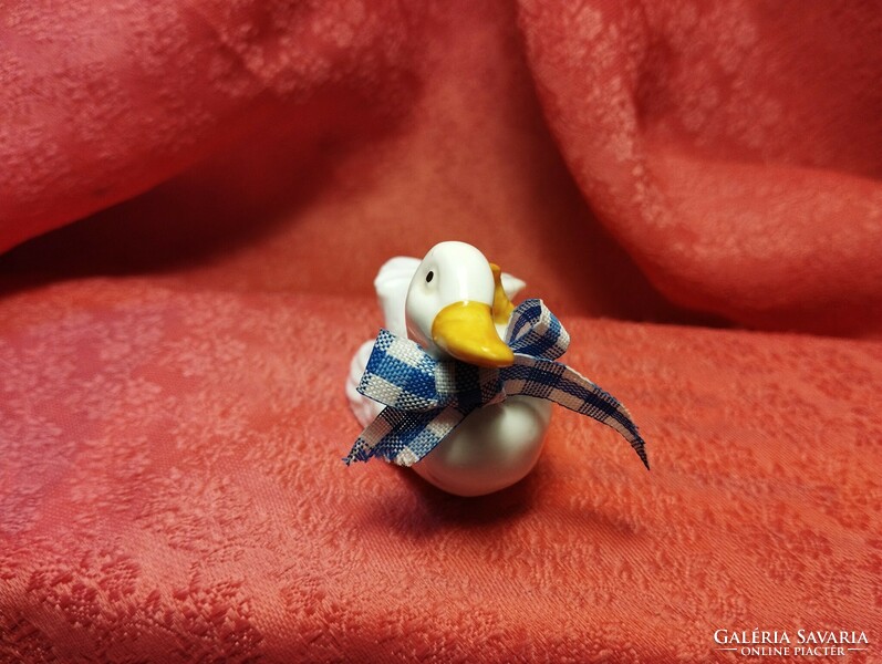 Miniature porcelain duck in an interesting pose