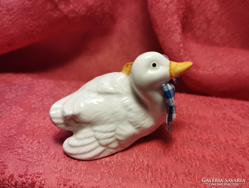 Miniature porcelain duck in an interesting pose