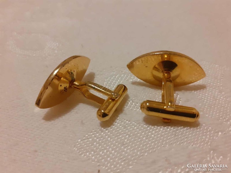 Gold colored Marlboro cufflink decorated with blue crystal