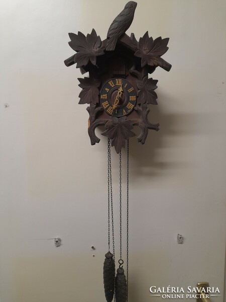 Alt German, Germay 19th century, authentic wood-carved Black Forest wall clock with a chain and striking cuckoo.