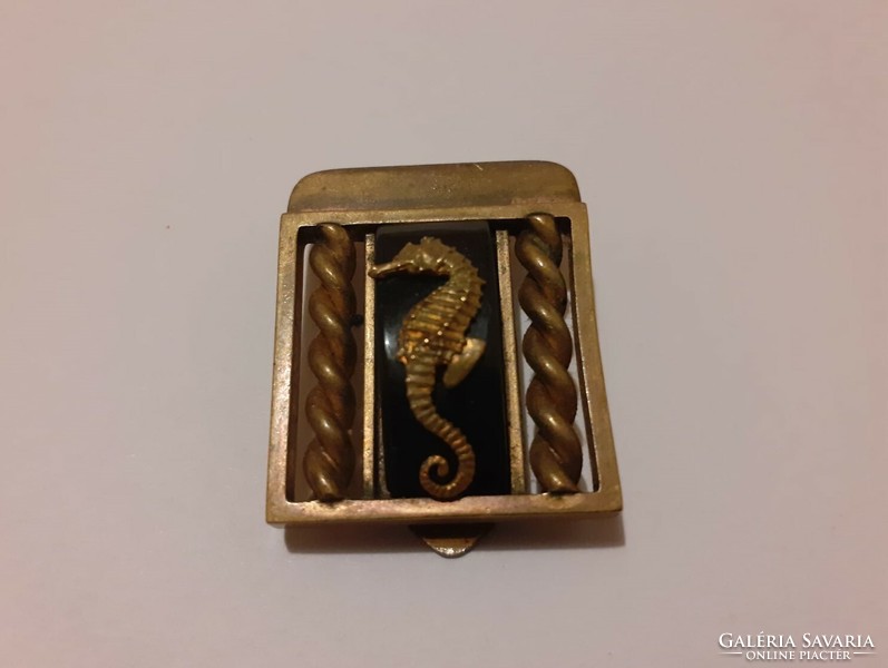 Vintage copper-colored clothespin decorated with a seahorse