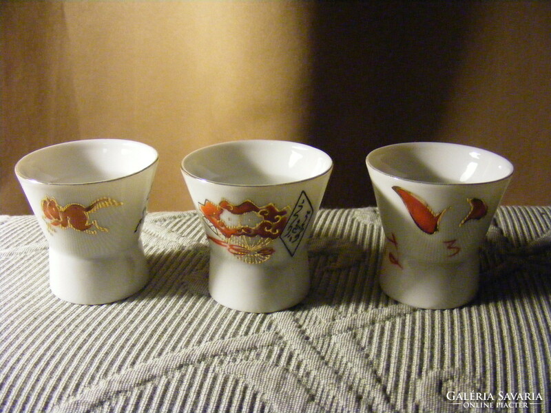 3 porcelain sake glasses with magnifying erotic images on the bottom