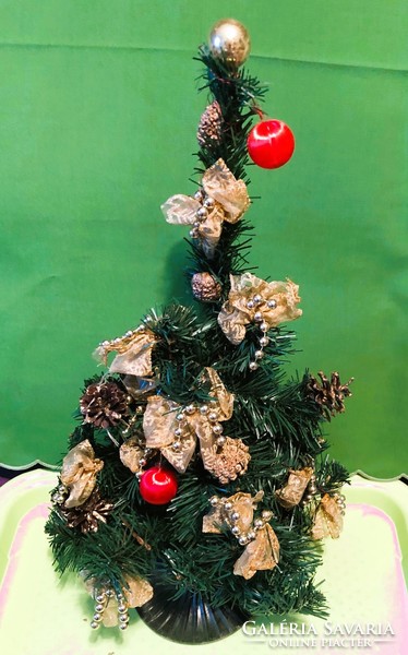 Small old artificial Christmas tree with base