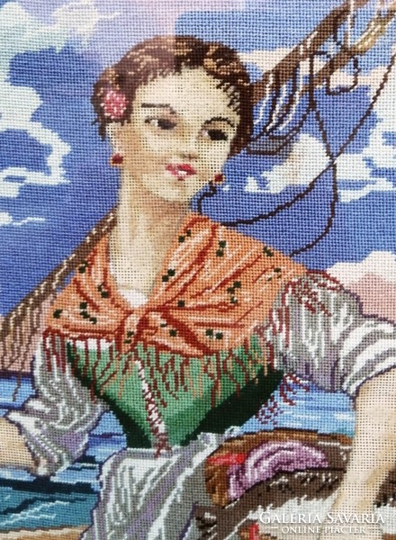 A fishing girl with her catch, a finely crafted tapestry in a glazed frame