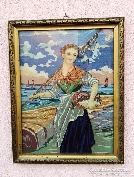 A fishing girl with her catch, a finely crafted tapestry in a glazed frame