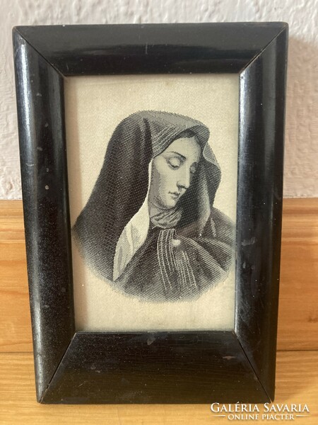 Virgin Mary in a black wooden frame