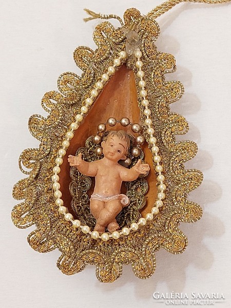 Handmade Christmas tree decoration with baby Jesus in the manger