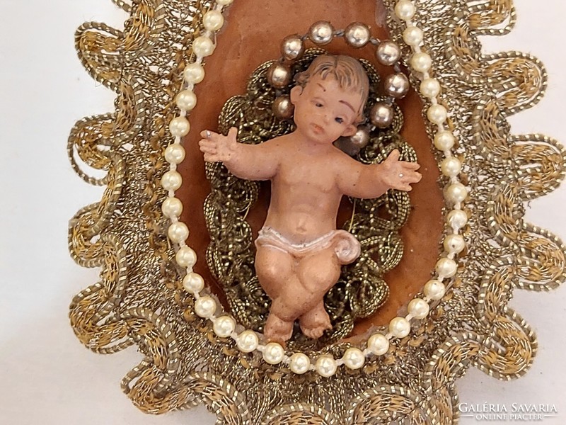 Handmade Christmas tree decoration with baby Jesus in the manger