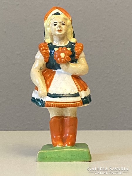 Small painted ceramic statue of a girl in national costume