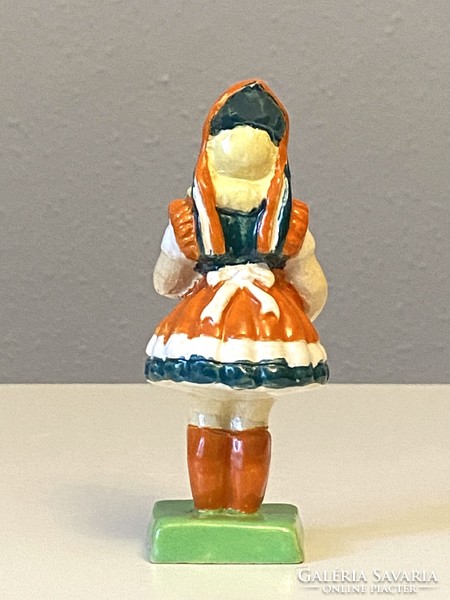 Small painted ceramic statue of a girl in national costume