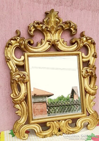 A robust mirror with a baroque style Florentine frame, a unique contemporary piece