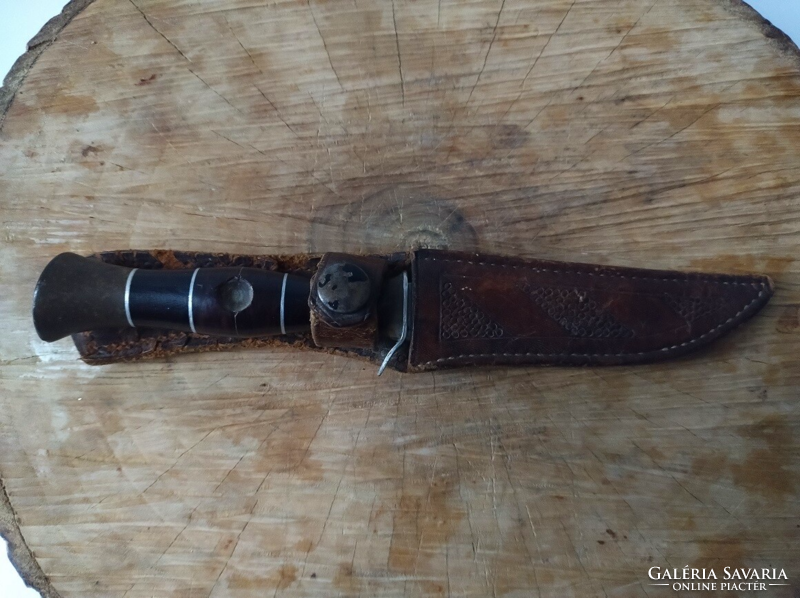 Old steel hunting knife with leather sheath