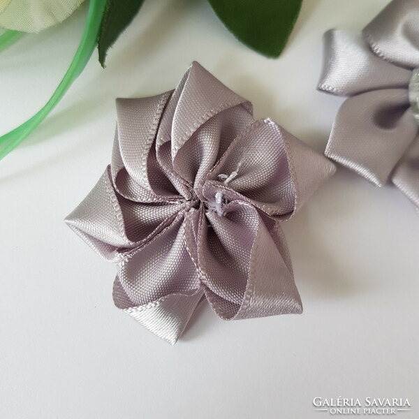 Silver-colored satin flower with a heart-shaped, shiny decoration