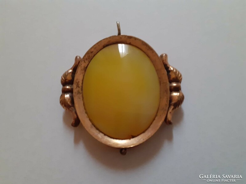 Old large gold colored pendant jade? With a stone
