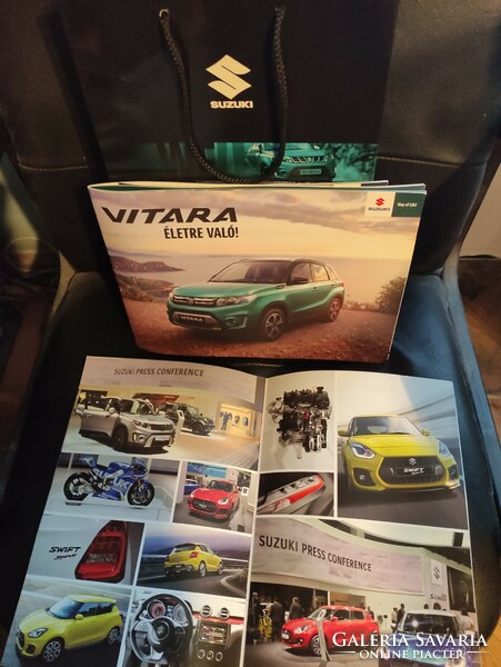 Suzuki car catalogs + advertising bag in one.