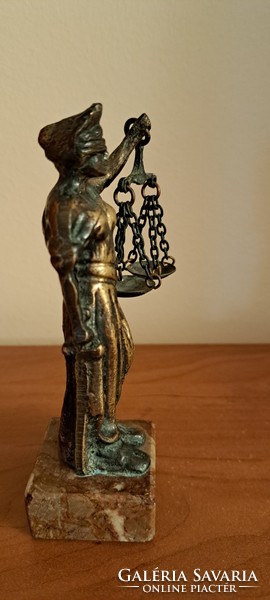 Antique bronze statue of justice on a marble base