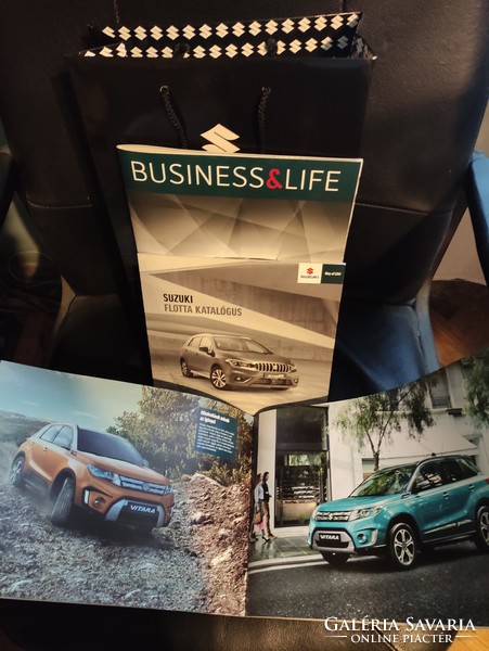 Suzuki car catalogs + advertising bag in one.