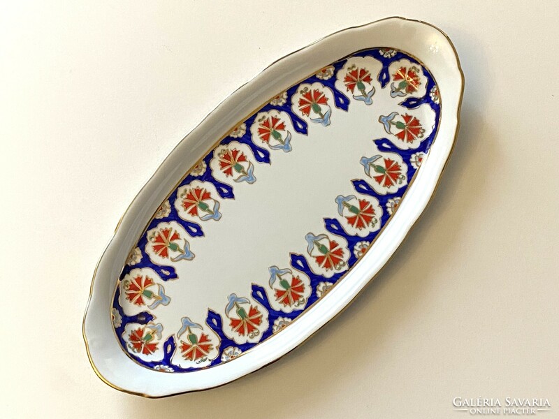An oblong porcelain tray with painted red and blue flowers