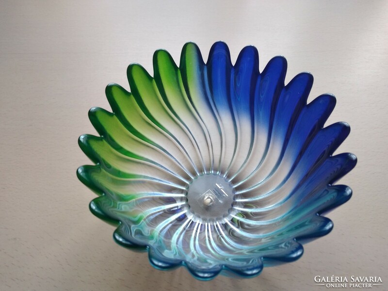 A glass bowl with a frilled edge, blue-green and turquoise color transition