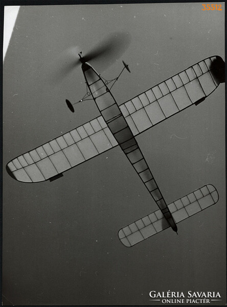 Larger size, photo art work by István Szendrő. Model airplane with explosive engine in the air, 1930