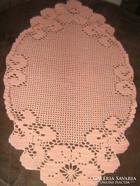 Beautiful vintage floral handmade crochet oval salmon on pink tablecloth