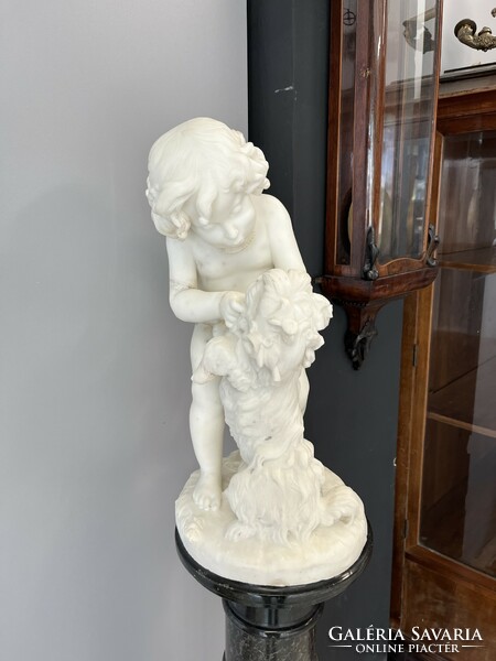 Carved marble statue with marble postman.