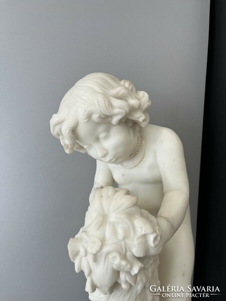 Carved marble statue with marble postman.