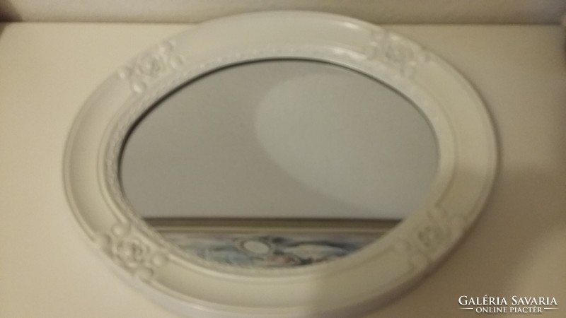 A small mirror with a white frame, very beautiful