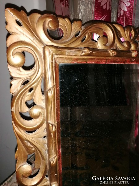 Mirror in a gilded, carved wooden frame