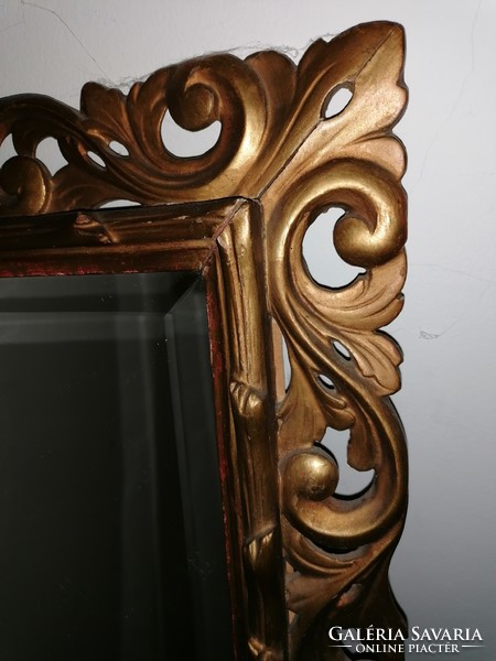 Mirror in a gilded, carved wooden frame