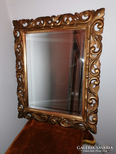 Mirror in a gilded, carved wooden frame
