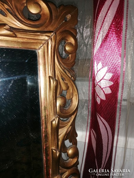 Mirror in a gilded, carved wooden frame