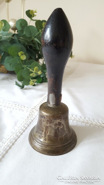 Old copper bell with wooden handle
