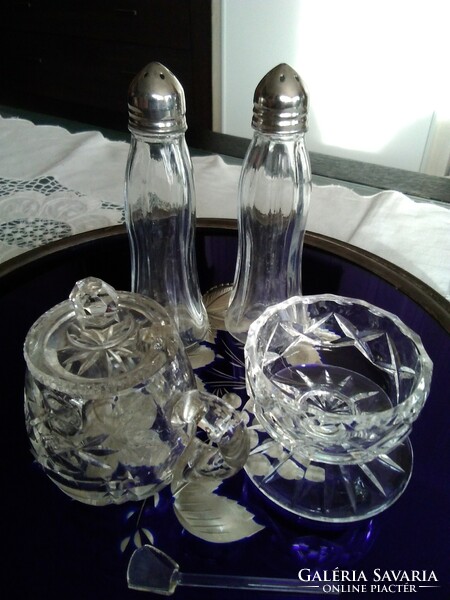 Stylish glass spice holders together on the laid table.