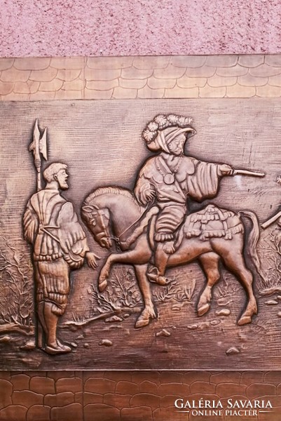 Going to war. A giant-sized, multi-shaped copper relief plaque