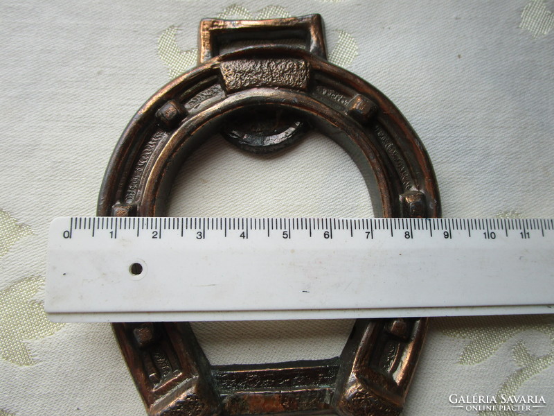 A horseshoe-shaped metal object might be a beer opener