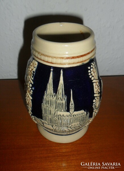 Beer mug with German embossed pattern. 11 cm high.