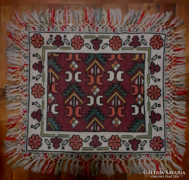 Old beautiful hand-made tapestry table cloth with a fringe on the edge