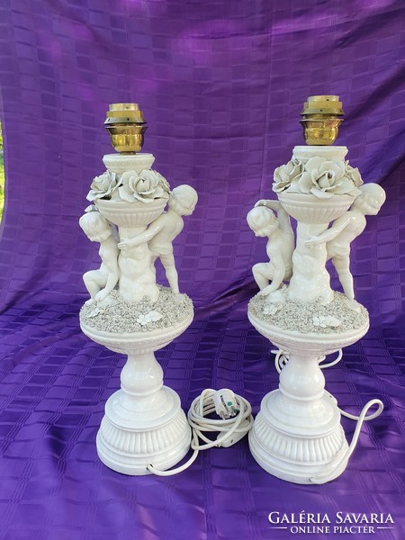 A pair of huge putto lamps