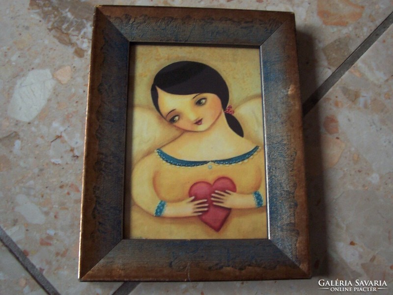Little girl in heart picture frame