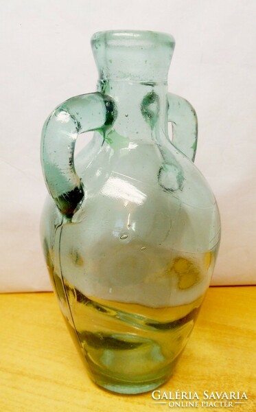 Antique amphora-shaped bottle with a molded ear with bubble inclusions